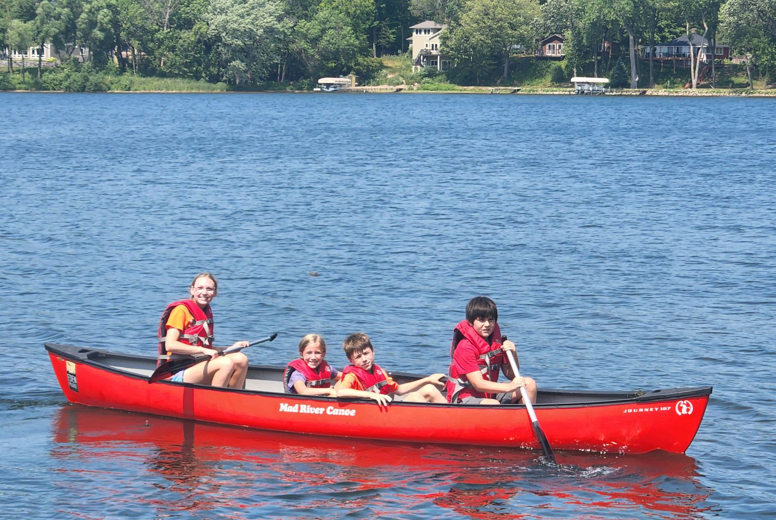 Day camp kids canoeing on the lake