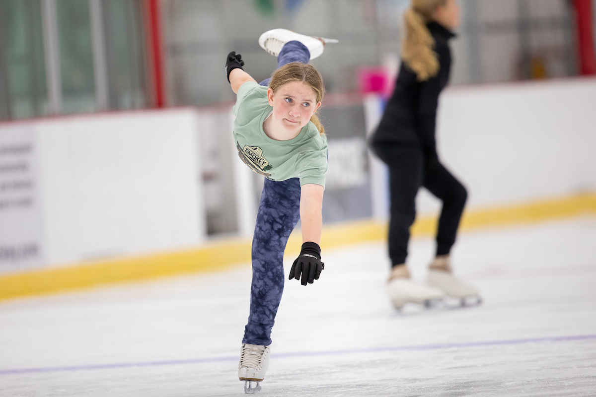 two girls ice skating at the Community Center ice rink