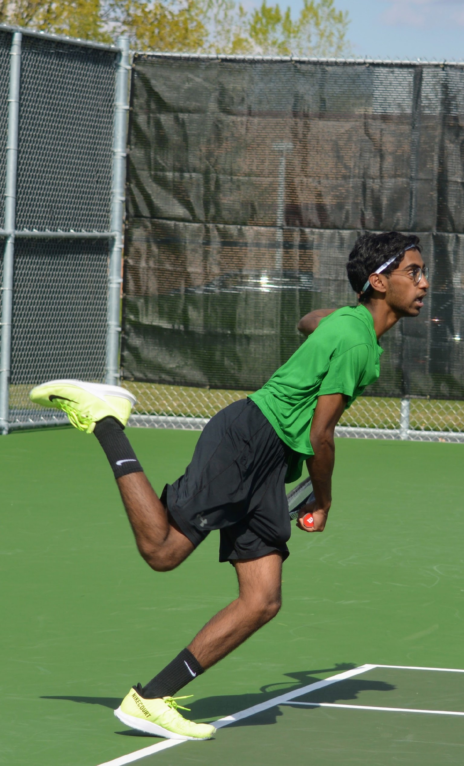 Photo of tennis instructor Shrey in action on a tennis court