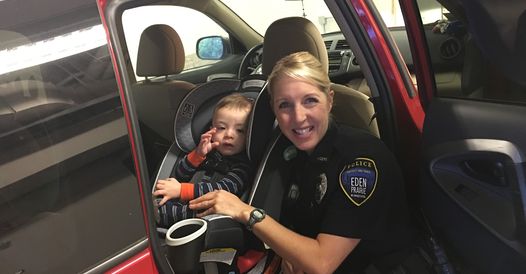 An EPPD officer with a child in a car seat