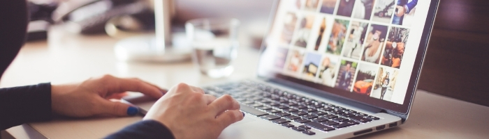 Hands typing on laptop