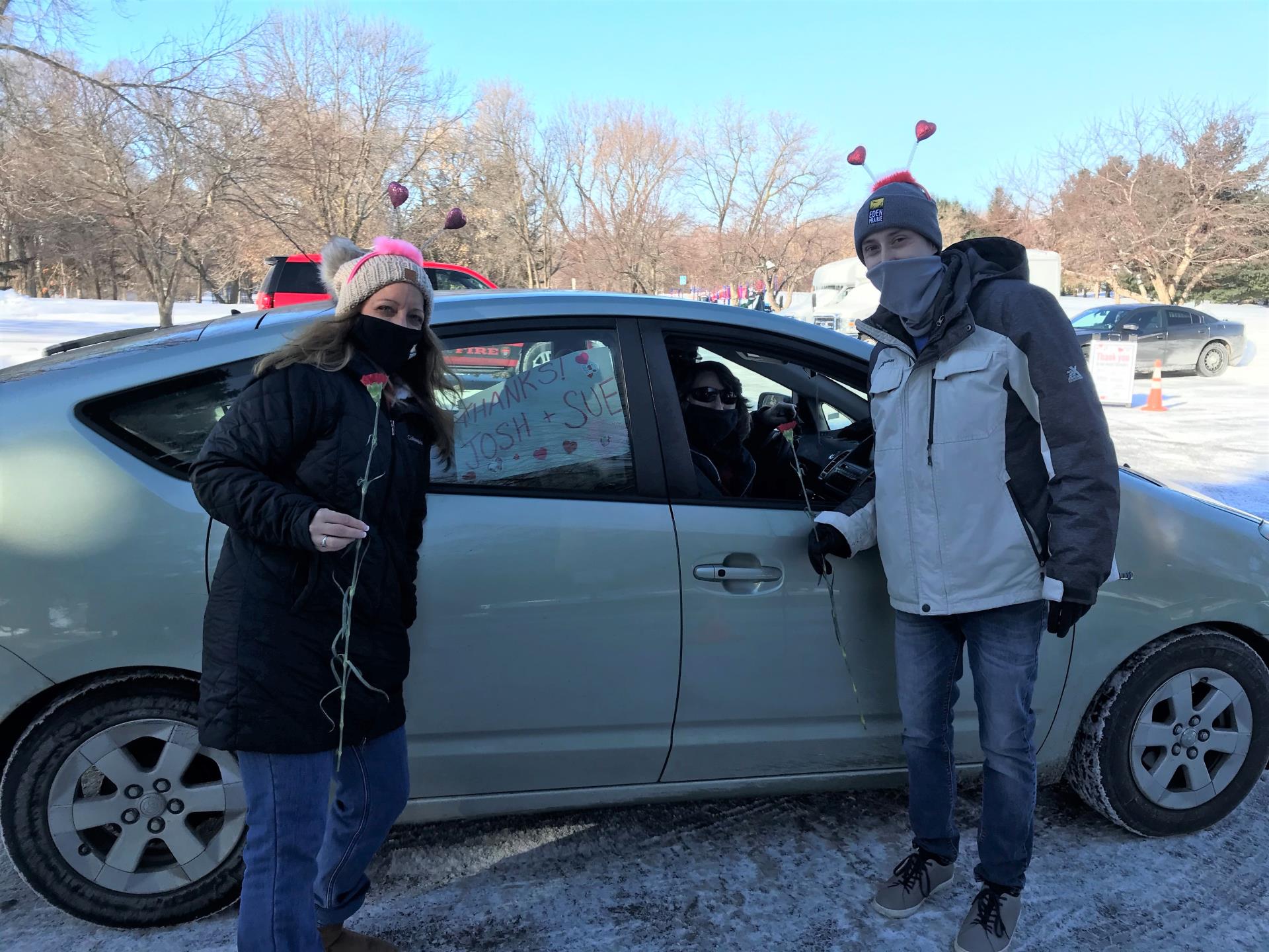 Sue and Josh handing out Valentine's goodies at the drive-thru