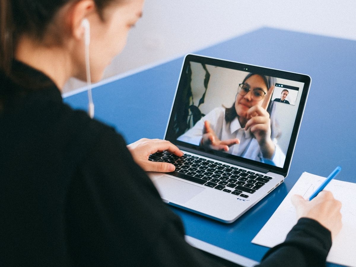 Woman talking to another on a computer