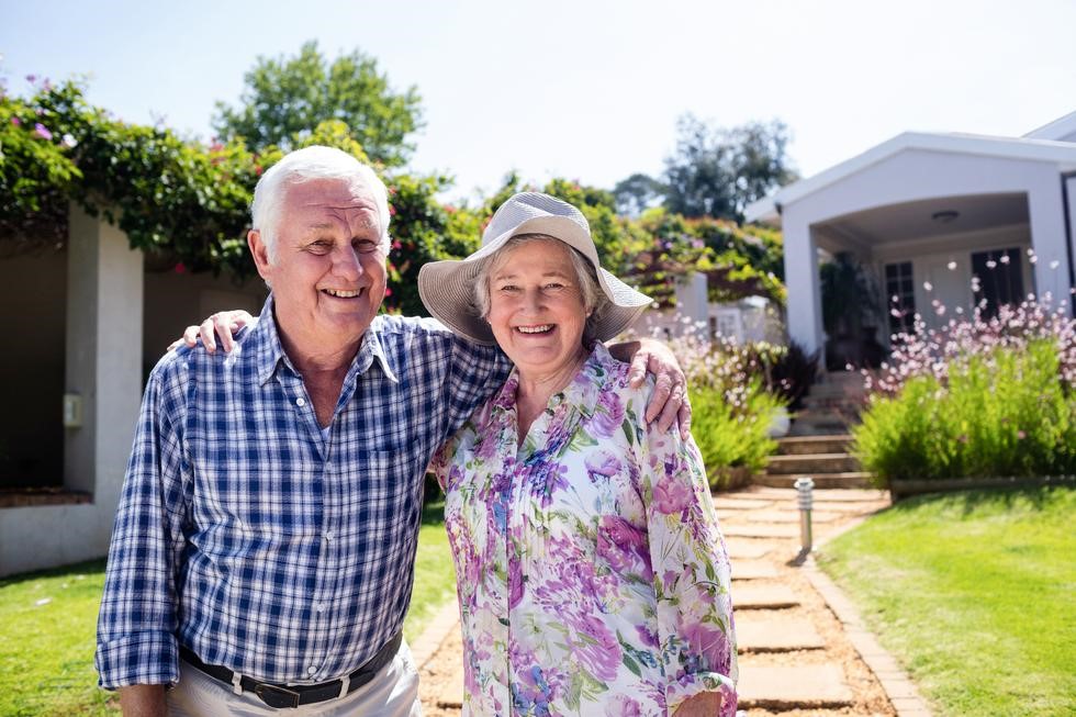 Happy couple in front of house - Copy