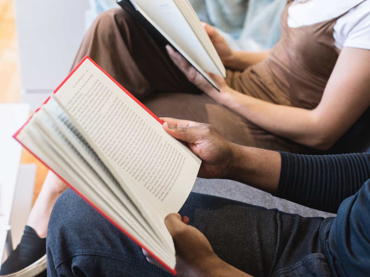 Two people holding books