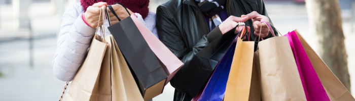 Two people holding shopping bags